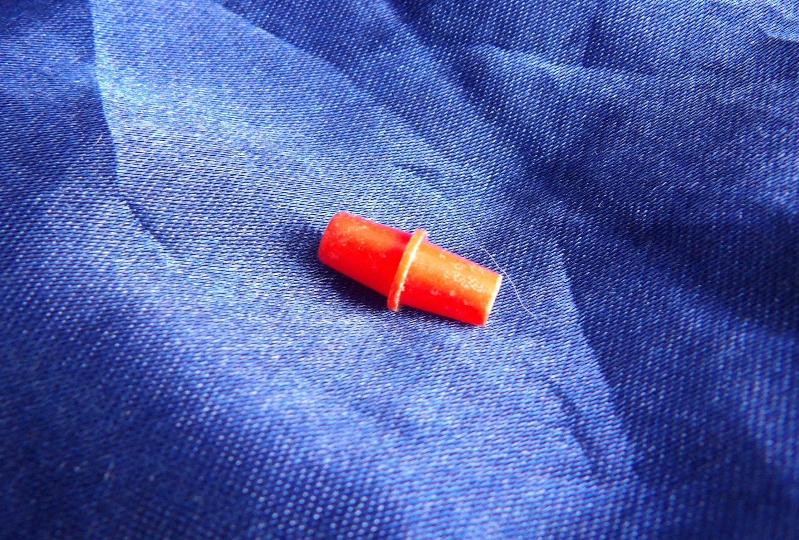 Red plastic Solitaire game piece