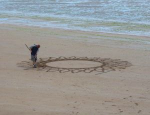A sand broom artist